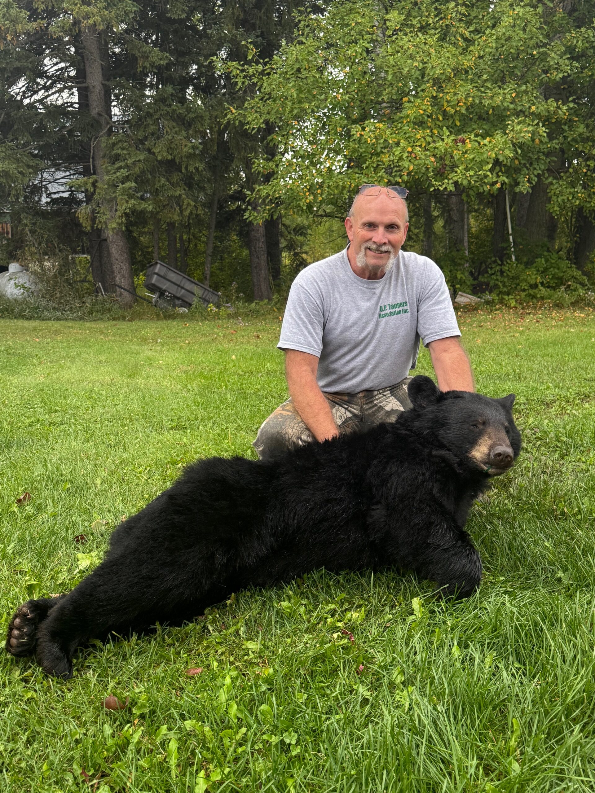 Photo of successful black bear hunter with bear